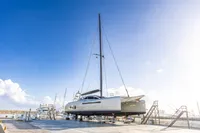 2018 Tag 60 catamaran on dry dock under clear blue sky.