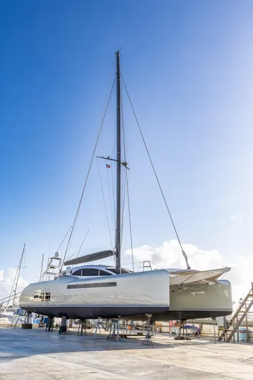  Yacht Photos Pics Sleek 2018 Tag 60 catamaran on dry dock under clear blue sky.