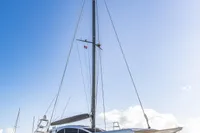 Sleek 2018 Tag 60 catamaran on dry dock under clear blue sky.