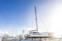 Sailboat Tag 60, 2018 model, docked under clear blue sky.