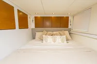 Luxurious bedroom interior in 2018 Tag 60, featuring elegant bedding and wooden accents.