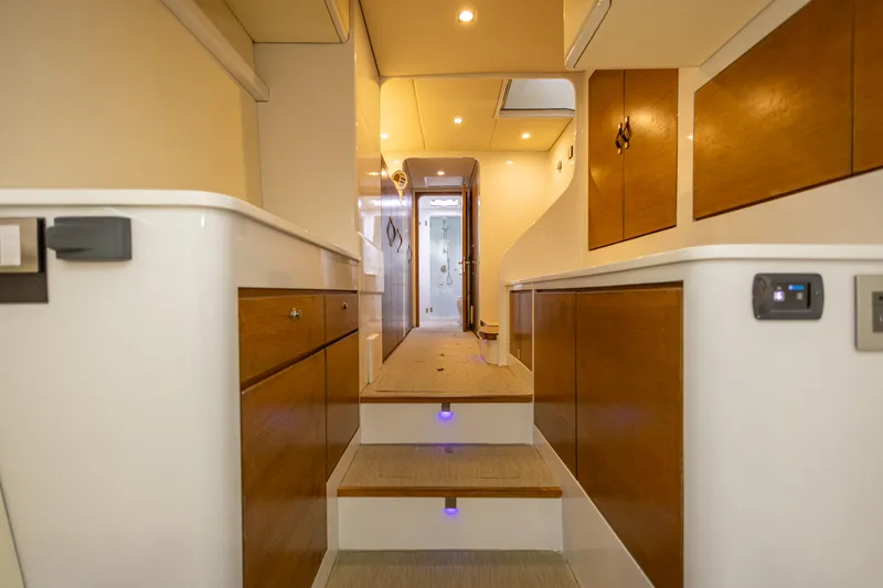  Yacht Photos Pics Luxurious interior of a 2018 Tag 60 yacht with wooden accents and modern lighting.