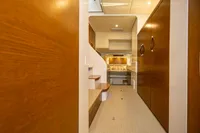 Luxurious interior of 2018 Tag 60 yacht with wooden finishes and cozy bedroom.