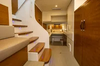 Luxurious interior of 2018 Tag 60 yacht with wooden stairs and modern furnishings.