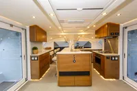 Luxurious interior of 2018 Tag 60 yacht with modern kitchen and elegant wood finishes.