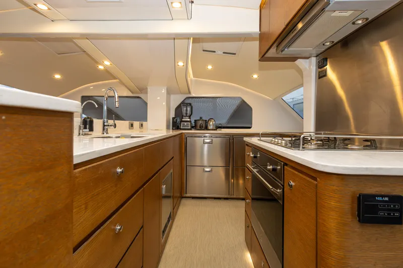  Yacht Photos Pics Luxurious yacht kitchen interior with modern appliances, wood cabinetry, and sleek design, Tag 60 model, 2018.