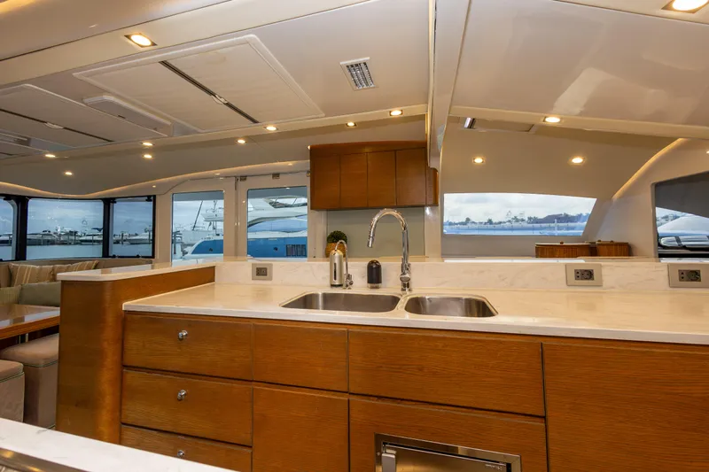  Yacht Photos Pics Luxurious yacht interior with modern kitchen, dual sinks, and panoramic windows. Tag 60, 2018 model.