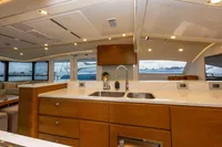 Luxurious yacht interior with modern kitchen, dual sinks, and panoramic windows. Tag 60, 2018 model.
