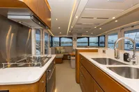 Luxurious yacht interior with modern kitchen and seating area, Tag 60 model, 2018.