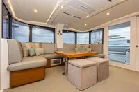 Luxurious interior of 2018 Tag 60 yacht with plush seating and elegant table.