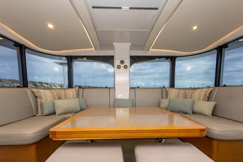  Yacht Photos Pics Luxurious interior of 2018 Tag 60 yacht with panoramic windows and plush seating.