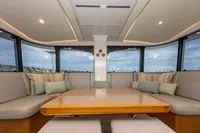 Luxurious interior of 2018 Tag 60 yacht with panoramic windows and plush seating.