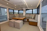 Luxurious interior of 2018 Tag 60 yacht with spacious seating and panoramic windows.