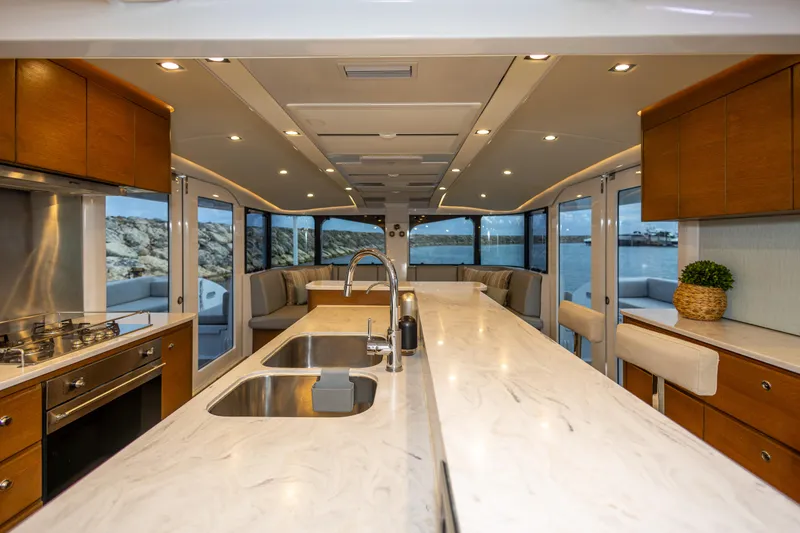  Yacht Photos Pics Luxurious interior of 2018 Tag 60 yacht with modern kitchen and scenic ocean view.