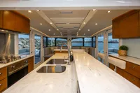 Luxurious interior of 2018 Tag 60 yacht with modern kitchen and scenic ocean view.