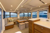 Luxurious interior of 2018 Tag 60 yacht with modern seating and panoramic windows.