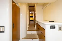 Interior hallway of 2018 Tag 60 yacht, featuring wooden accents and modern design.