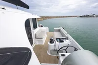 Modern Tag 60 boat interior with seating, steering wheel, and ocean view, 2018 model.