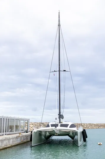  Yacht Photos Pics 2018 Tag 60 catamaran docked in a marina, overcast sky.