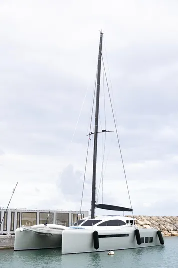  Yacht Photos Pics 2018 Tag 60 catamaran docked in a marina under cloudy skies.