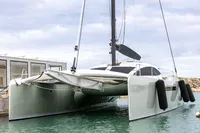 2018 Tag 60 catamaran docked in marina, featuring sleek design and modern architecture.