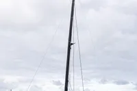Sleek 2018 Tag 60 catamaran docked in calm waters under cloudy skies.