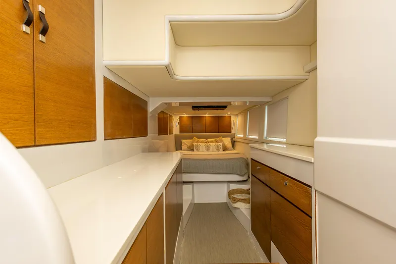  Yacht Photos Pics Luxurious interior of 2018 Tag 60 yacht with cozy bedroom and wooden cabinetry.