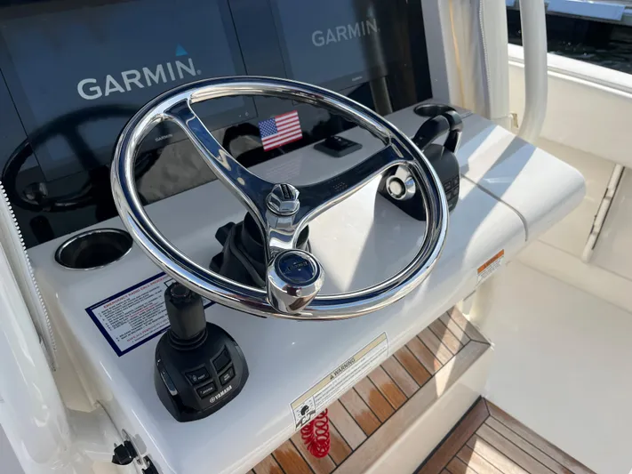  Yacht Photos Pics 2020 Jupiter 34 Center Console helm with Garmin displays and American flag.