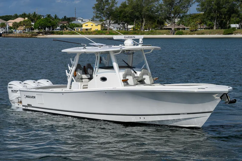  Yacht Photos Pics 2024 Regulator 37 boat cruising on a calm waterway, featuring sleek design and advanced technology.