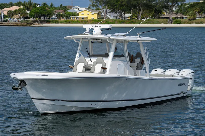  Yacht Photos Pics 2024 Regulator 37 boat cruising on calm water near a coastal area.