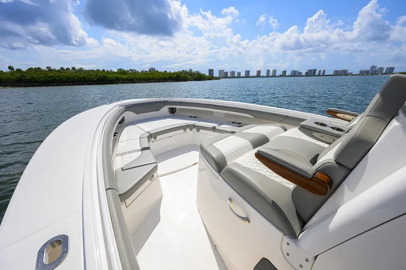  Yacht Photos Pics 2024 Regulator 37 boat interior with luxurious seating, overlooking a scenic waterfront view.