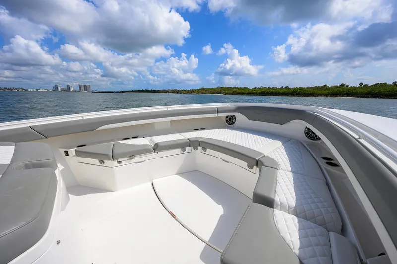  Yacht Photos Pics 2024 Regulator 37 boat with spacious seating, scenic water view, and blue sky.