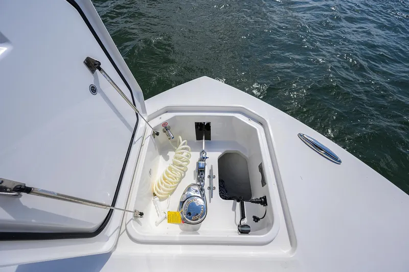  Yacht Photos Pics 2024 Regulator 37 boat anchor locker with coiled hose and winch, on calm water.