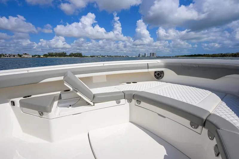  Yacht Photos Pics 2024 Regulator 37 boat interior with cushioned seating, ocean view, and blue sky.