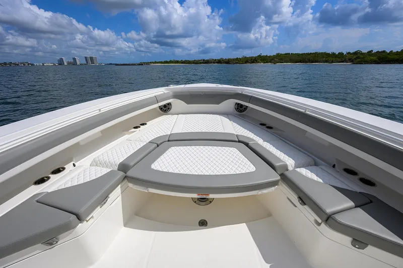  Yacht Photos Pics 2024 Regulator 37 boat interior with cushioned seating, ocean view, and blue sky.