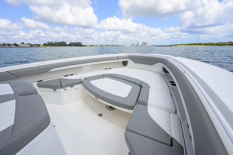  Yacht Photos Pics 2024 Regulator 37 boat interior with cushioned seating, on a calm water backdrop.