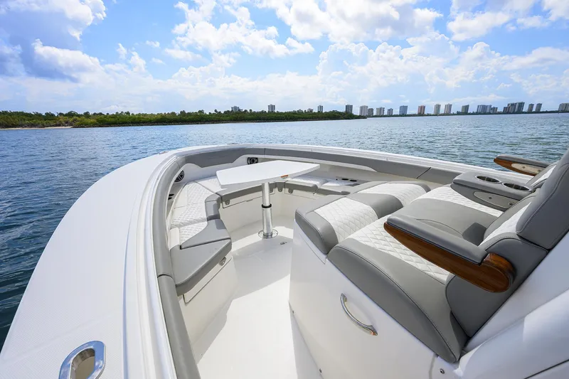  Yacht Photos Pics 2024 Regulator 37 boat with luxurious seating, cruising on a sunny day.