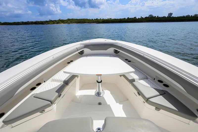  Yacht Photos Pics 2024 Regulator 37 boat interior with seating and table on calm water.