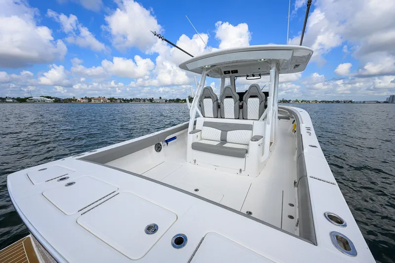  Yacht Photos Pics 2024 Regulator 37 boat on calm water under a blue sky with clouds.