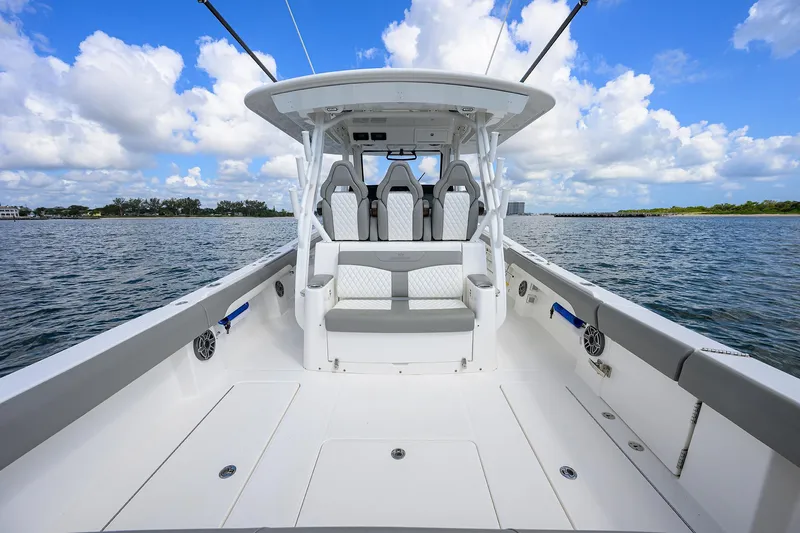  Yacht Photos Pics 2024 Regulator 37 boat on water, featuring spacious deck and seating under clear blue sky.