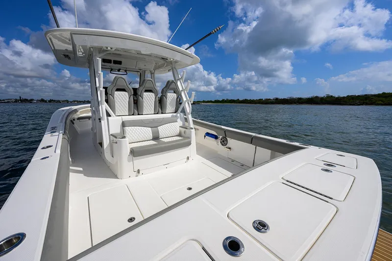  Yacht Photos Pics 2024 Regulator 37 boat with sleek design, spacious deck, and modern seating on open water.