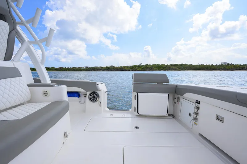  Yacht Photos Pics 2024 Regulator 37 boat interior with seating, overlooking calm waters and blue sky.