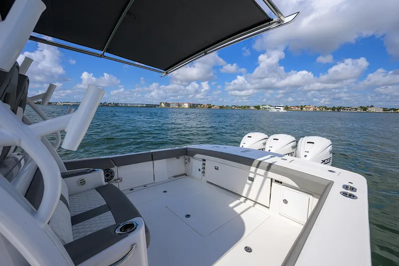  Yacht Photos Pics 2024 Regulator 37 boat on water, featuring spacious deck and triple outboard engines.