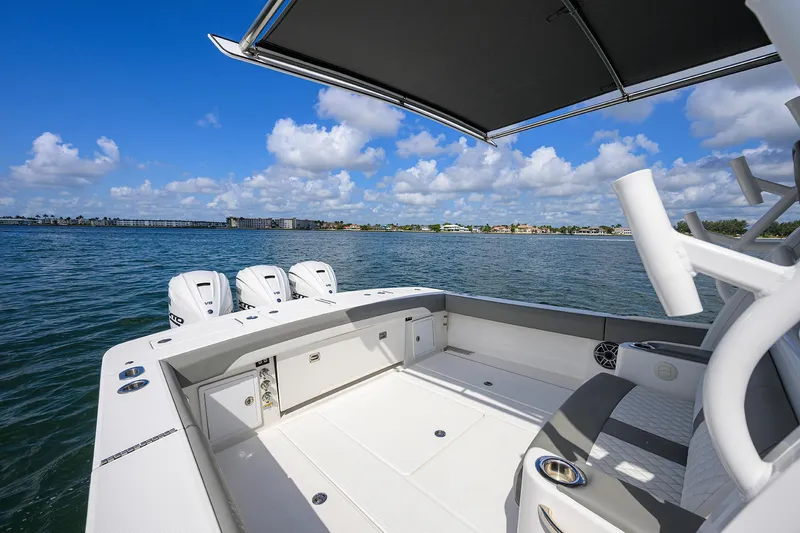  Yacht Photos Pics 2024 Regulator 37 boat with triple engines, spacious deck, and scenic water view.