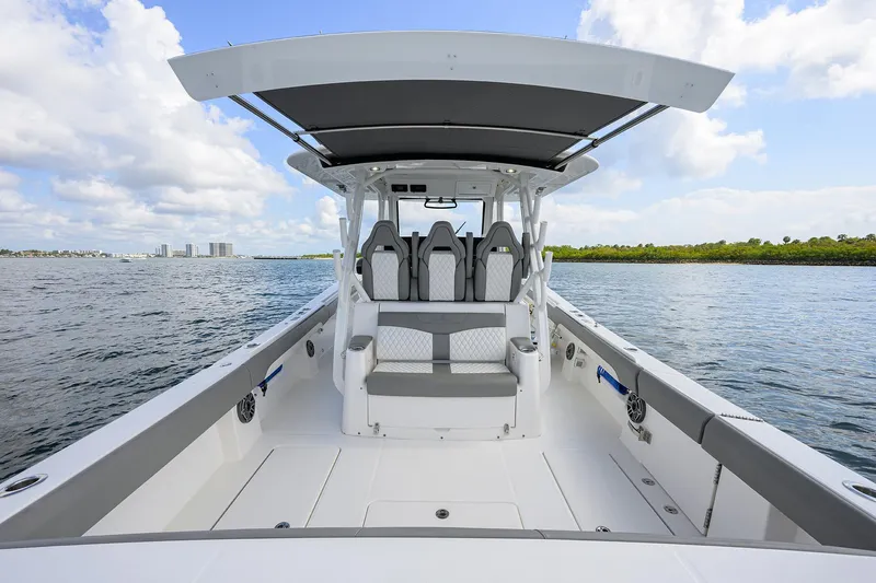  Yacht Photos Pics 2024 Regulator 37 boat with spacious deck and seating, cruising on open water.