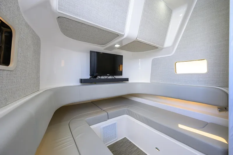 Yacht Photos Pics 2024 Regulator 37 cabin interior with TV, modern seating, and ambient lighting.