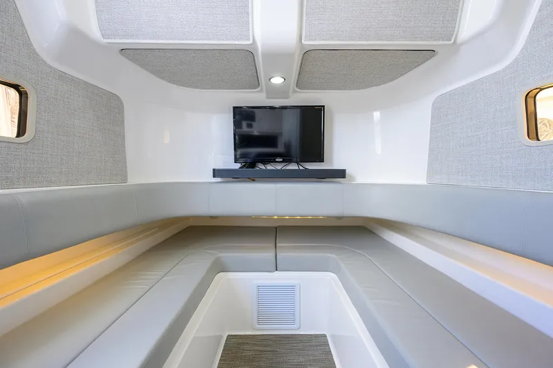  Yacht Photos Pics 2024 Regulator 37 cabin interior with TV, modern seating, and sleek design.