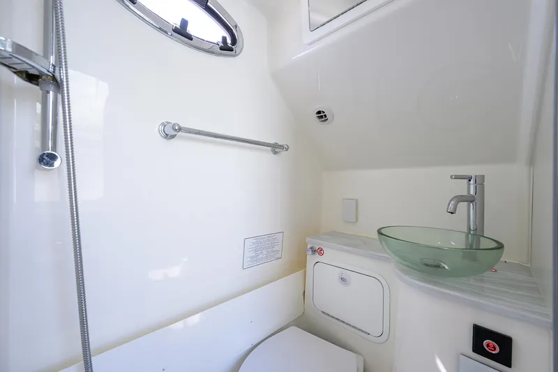  Yacht Photos Pics 2024 Regulator 37 boat bathroom with modern glass sink and sleek fixtures.