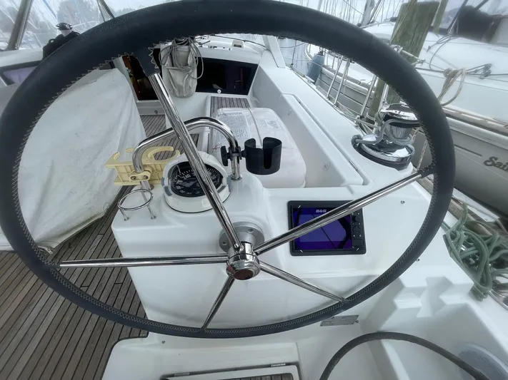 Joie De Vivre Yacht Photos Pics Steering wheel of 2014 Beneteau Oceanis 48 sailboat with navigation instruments.