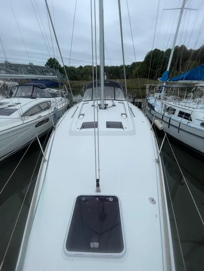 Joie De Vivre Yacht Photos Pics 2014 Beneteau Oceanis 48 sailboat docked, view of deck and surrounding boats.